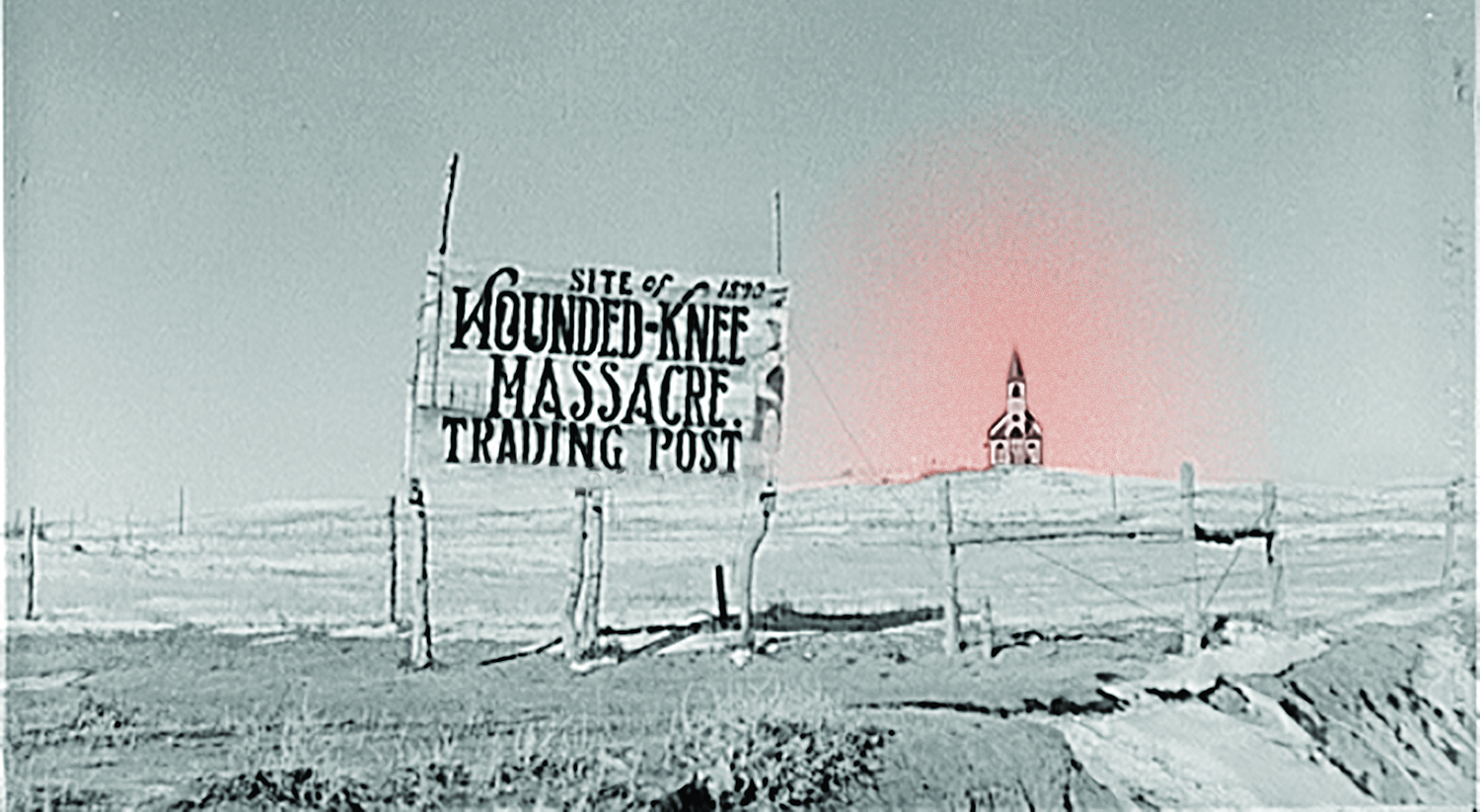 A Church in the Distance of a Wounded Knee Massacre Sign